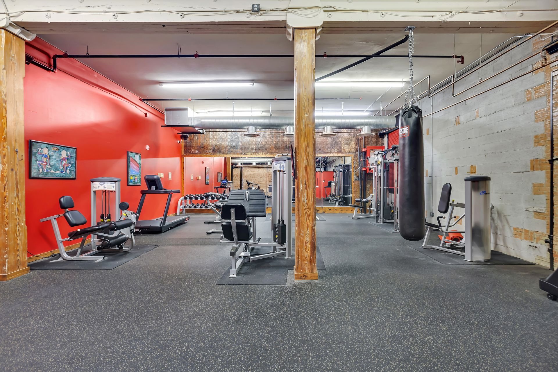 Fitness center under original brick and timber at 1900 Elm Lofts
