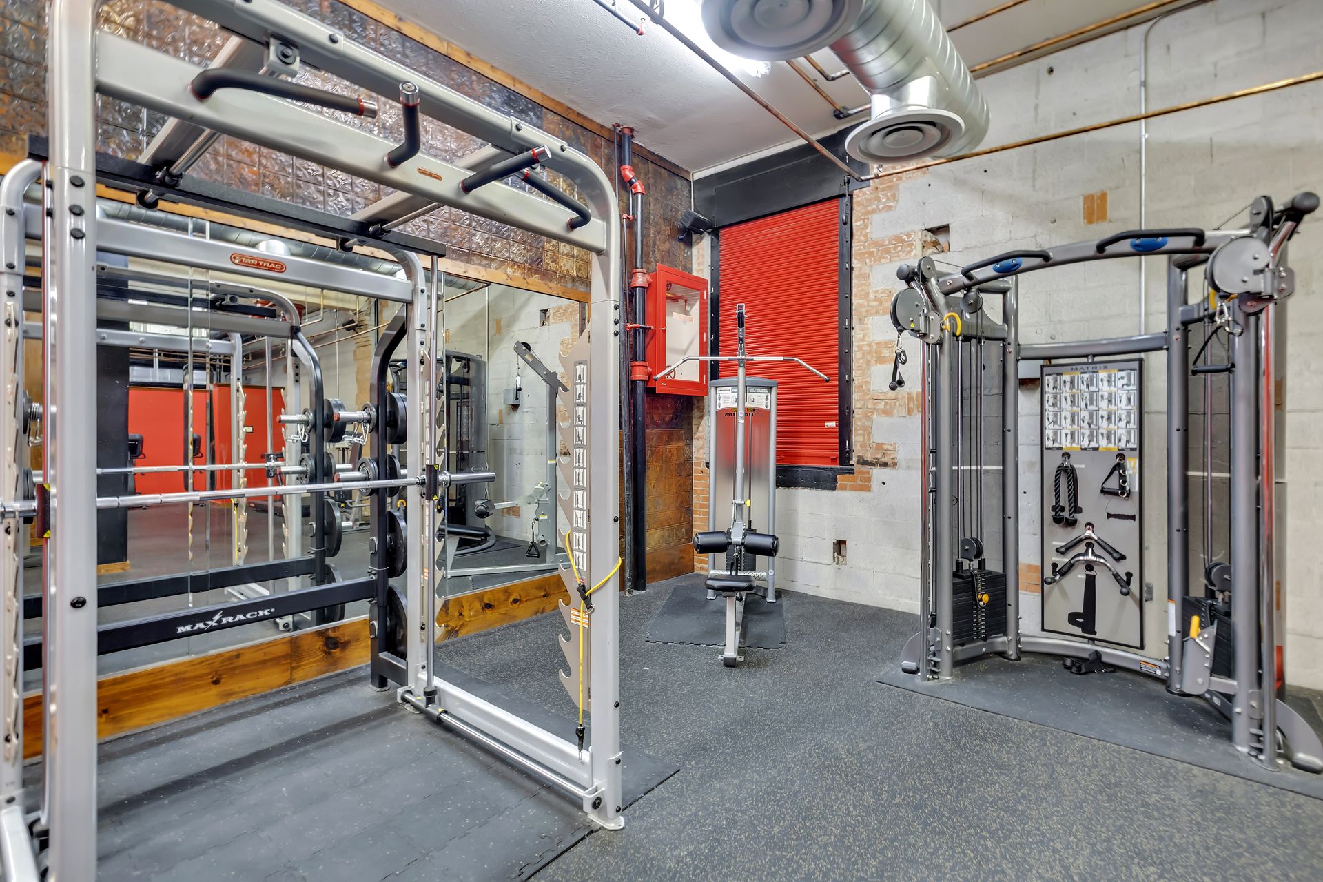 Power rack and cable station in the fitness center at 1900 Elm Lofts