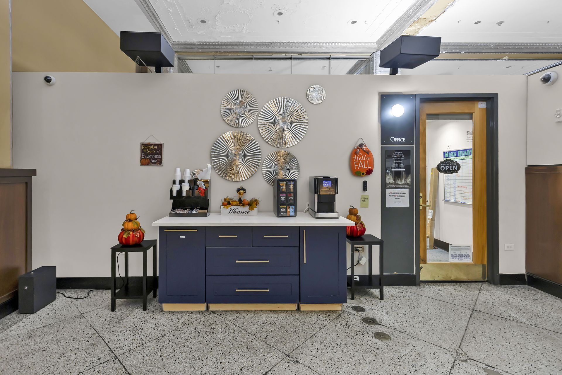 Coffee station beside the management office door in the lobby at 1900 Elm